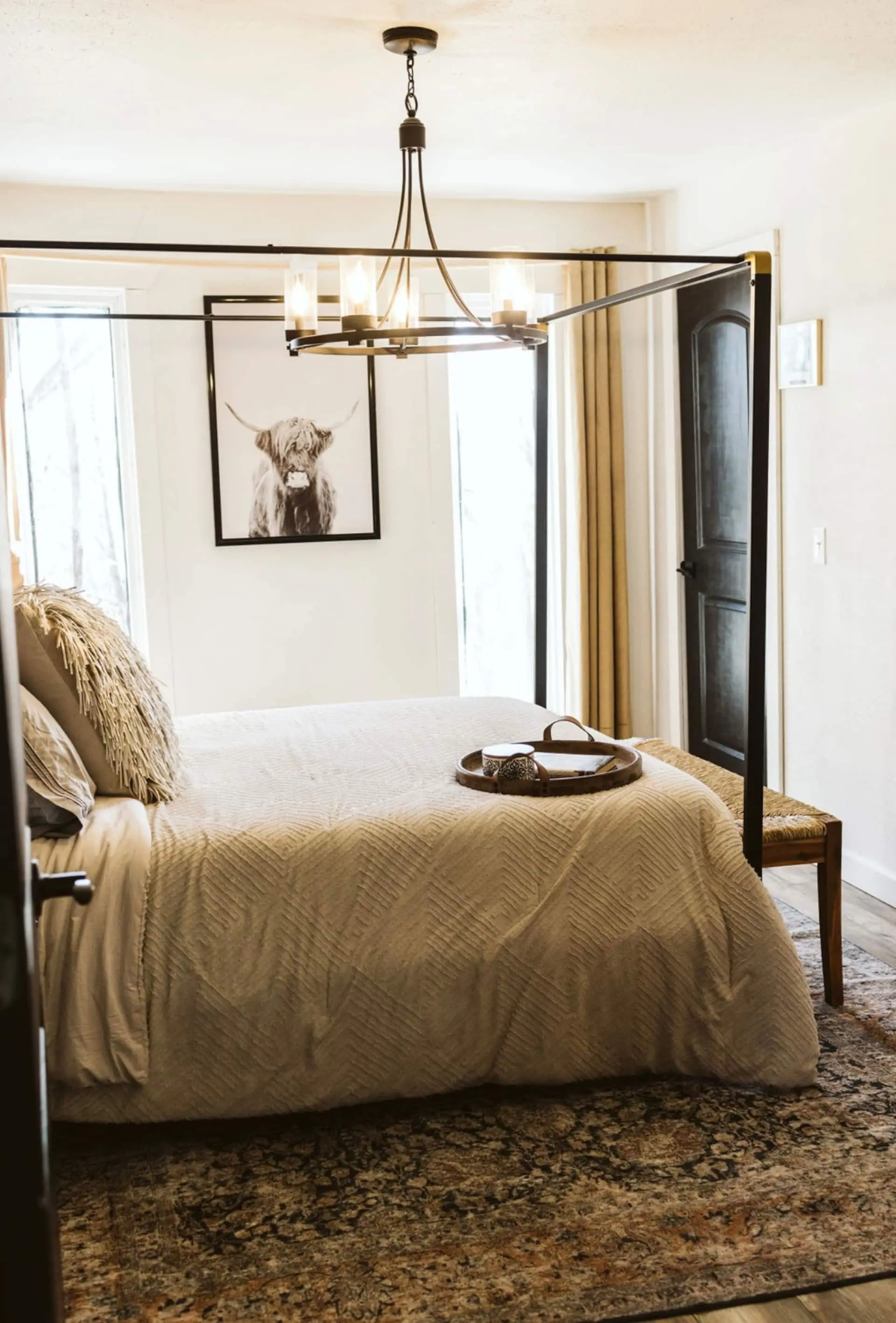 Bedroom 2 with a bear print, a beaded chandelier and a black barn-style door