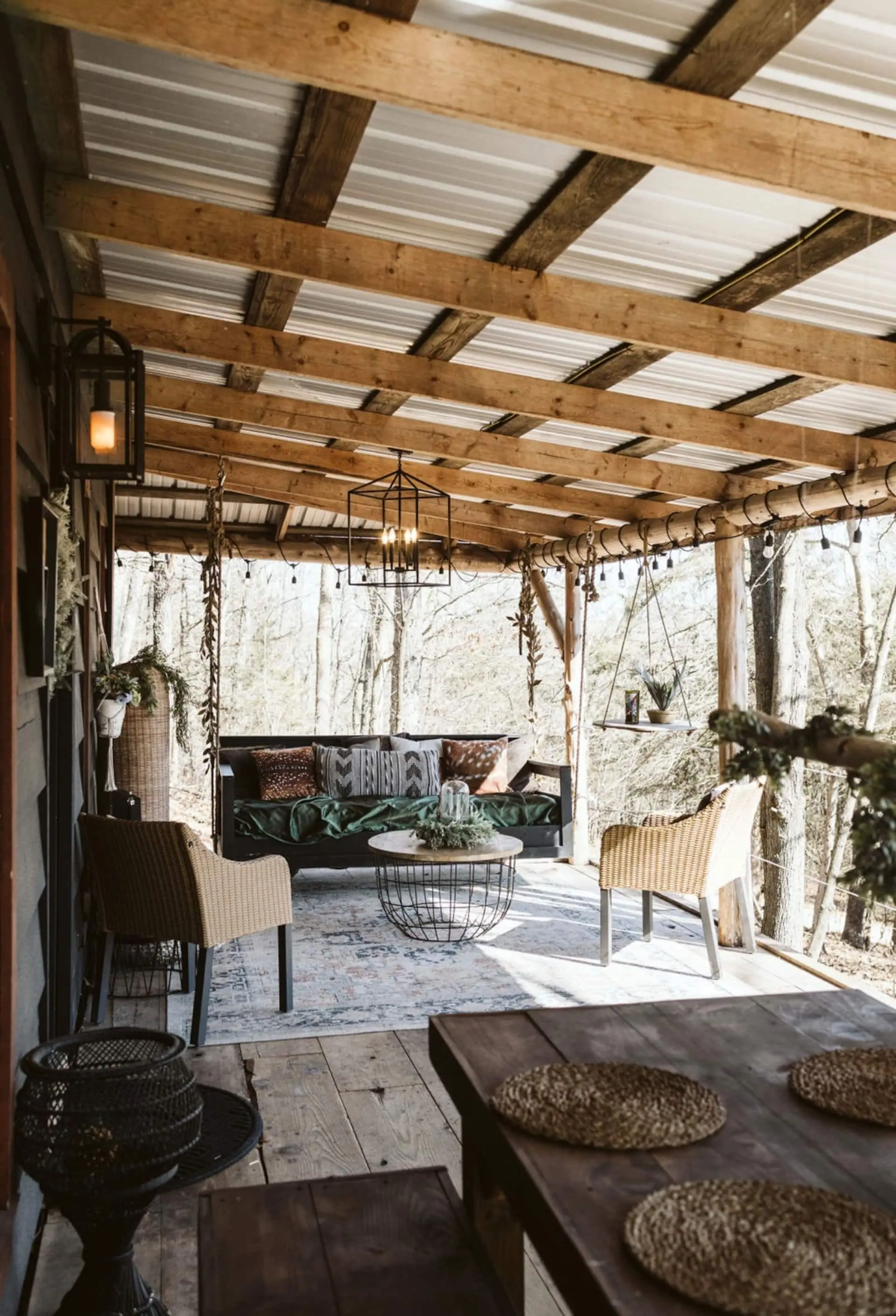 String lights and hanging chairs along the covered wraparound porch